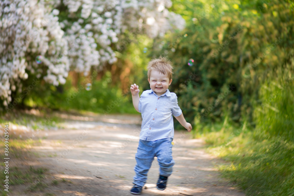 Child running in an apple orchard in spring Child running in an apple orchard in spring