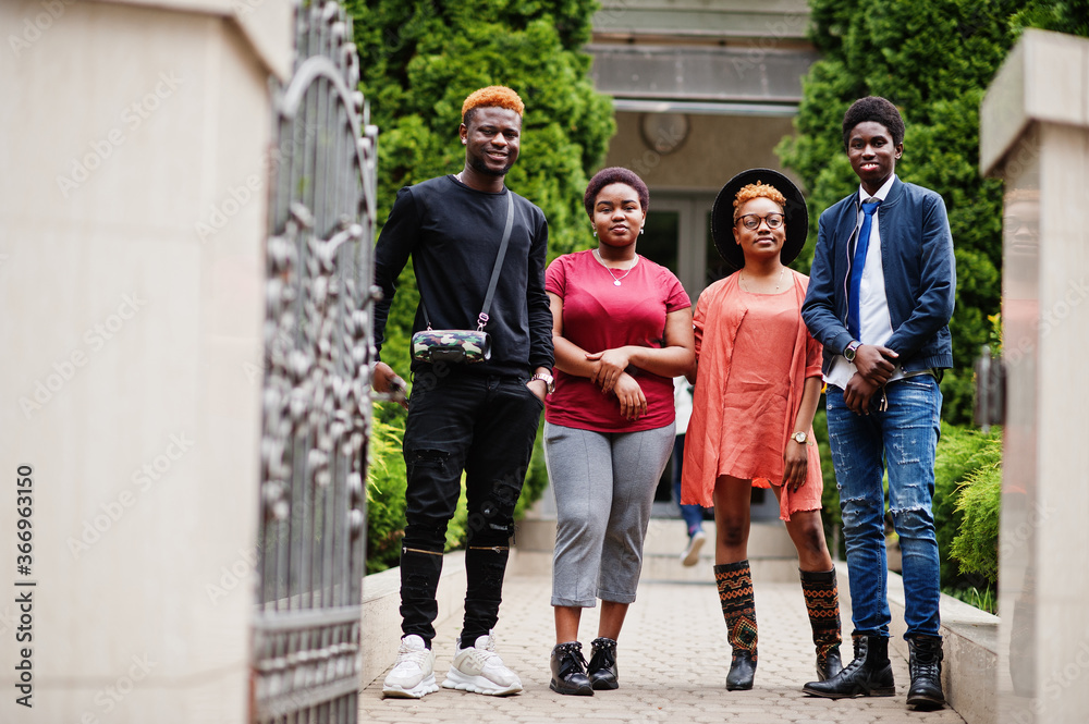 Fototapeta premium Four african friends having fun outdoors. Two black girls with guys.