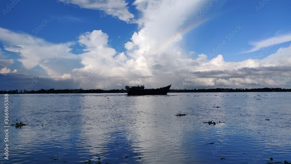 Boat on the River Landscape View with Rainbow