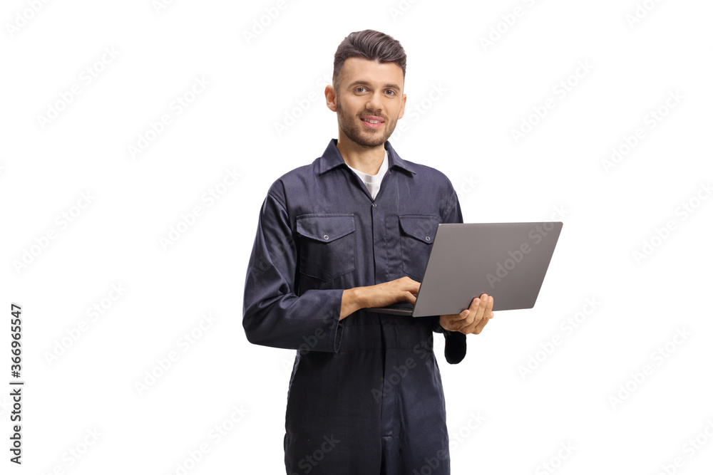 Auto mechanic worker holding a laptop computer and looking at the camera Auto mechanic worker holding a laptop computer and looking at the camera