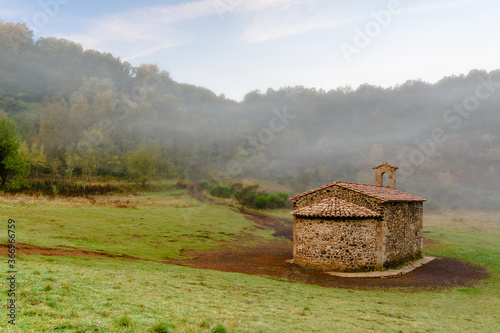 The Chapel of the Sta.Margarida Volcano, in the misty morning (Natural Park of Garrotxa, Catalonia, Spain)  photo