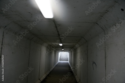 Passage souterrain réservé aux piétons éclairé par des néons