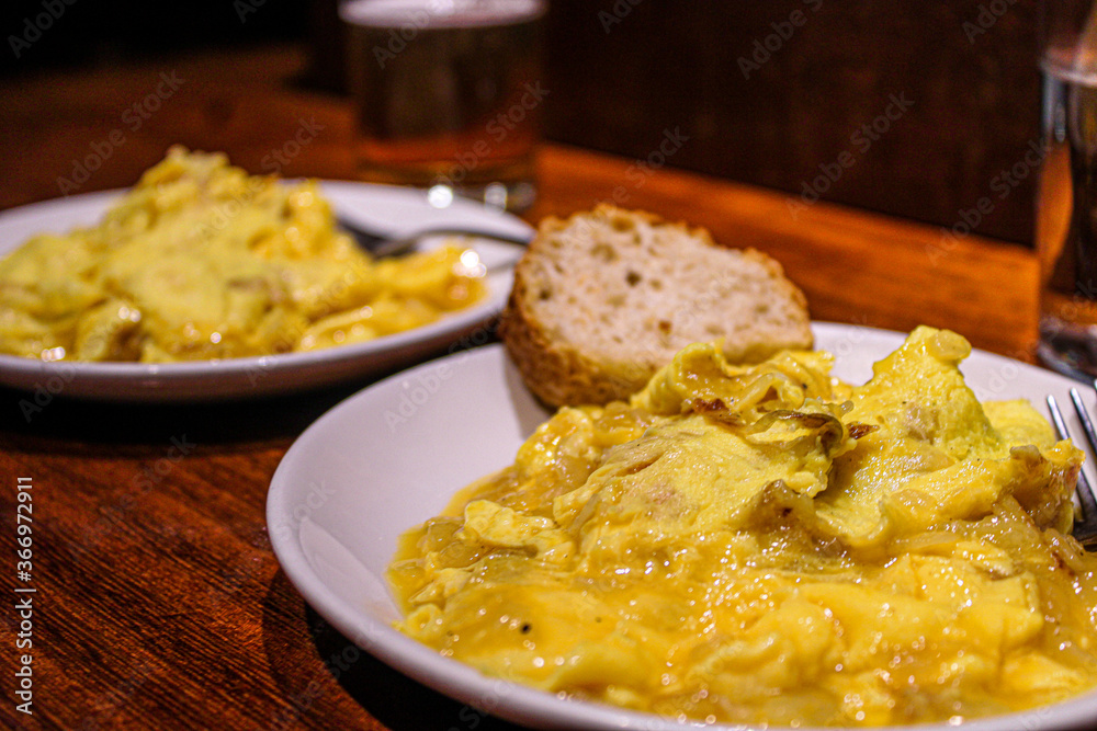 Potato and egg scrambled as a pintxo in a bar of the old town in San Sebastian. Basque Cuisine in a vegetarian pintxo. Potato and egg scrambled as a pintxo in a bar of the old town in San Sebastian. Basque Cuisine in a vegetarian pintxo.