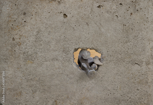 a hammer breaks through a concrete wall. hammer through concrete. Overcoming obstacles concept.