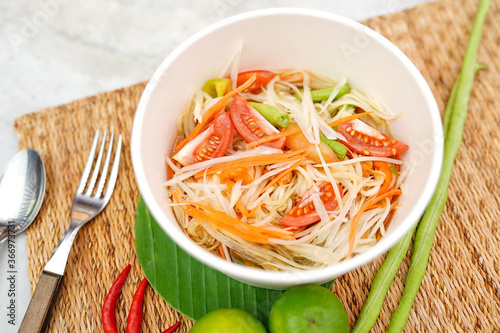 Top view and Close up papaya salad or ''Som tum Thai '' popular Thai food, mat decorating with ingredients background.