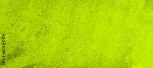 Vibrant green watercolor background with ragged strokes and uneven blurred paint. Abstract lime background for designs, layouts and patterns.