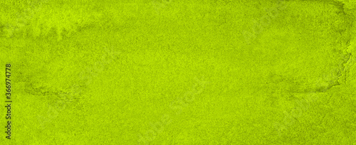 Vibrant green watercolor background with ragged strokes and uneven blurred paint. Abstract lime background for designs, layouts and patterns.