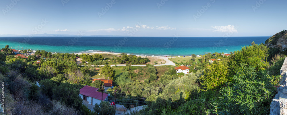 Panoramic view of houses and foliage by the sea