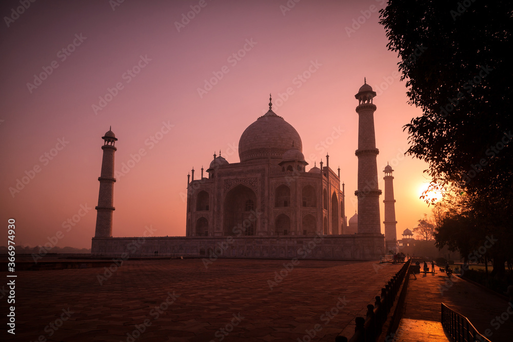 A beautiful view of the Taj Mahal seen in the dimming light during Sunrise