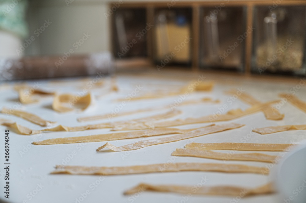 Fresh homemade pasta noodles drying on counter top