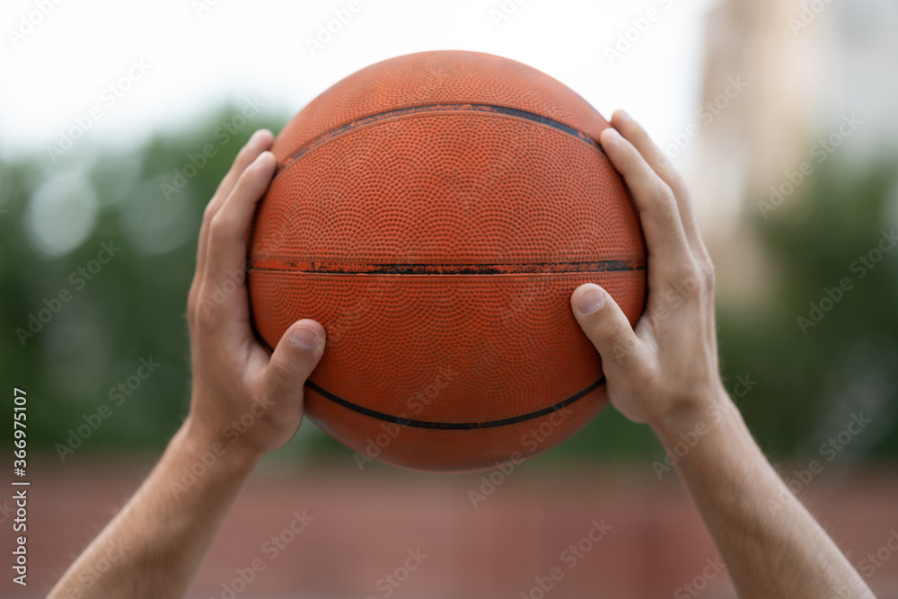 Basketball in the hands on the street