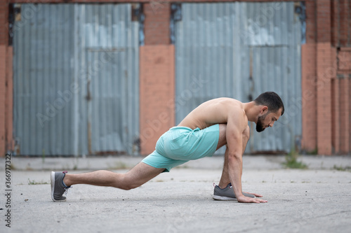 Man does a warm-up before training on the street. Workout, training, lifestyle
