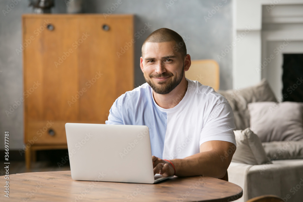 a handsome man with a beard at a laptop, communicating with loved ones a handsome man with a beard at a laptop, communicating with loved ones