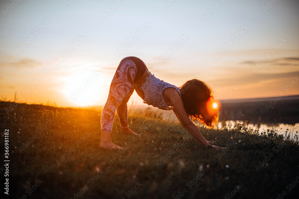 Yoga practice and meditation in nature in sunrise. Woman practicing near big river Kama. Yoga practice and meditation in nature in sunrise. Woman practicing near big river Kama.