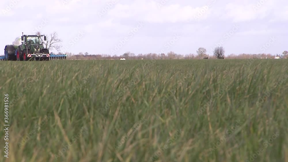 Manure injection on field. Tractor. Folding out manure injector. Farming. Netherlands. Fertilization Manure injection on field. Tractor. Folding out manure injector. Farming. Netherlands. Fertilization