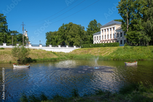 A fountain and two white boats with flowers in Kamenny Brook in Uglich, Yaroslavl Region.