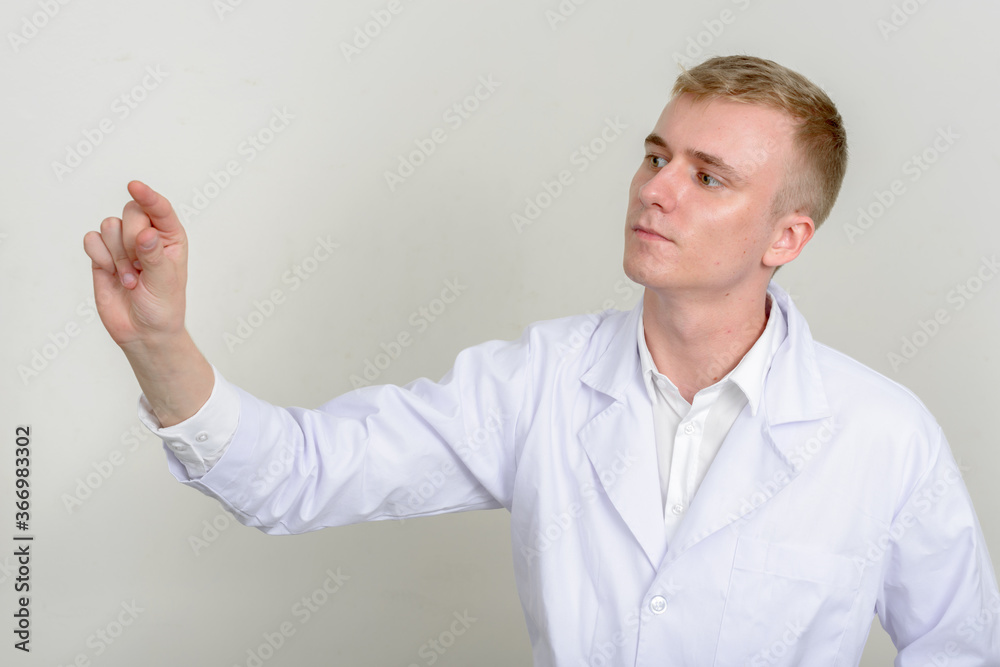 Portrait of young man doctor with blond hair