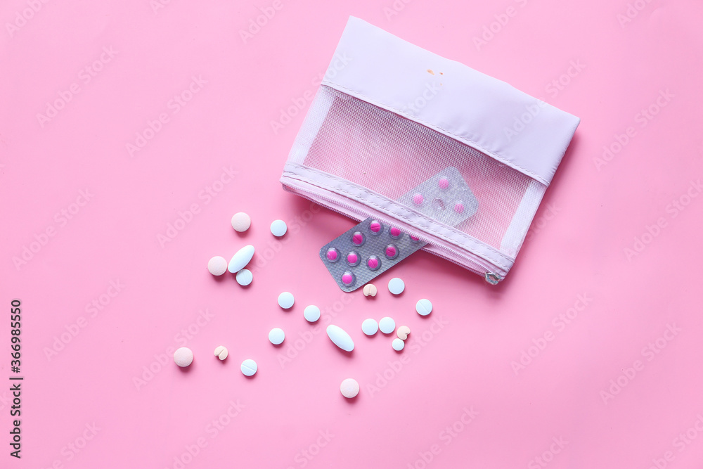 Top view of pills spilling on pink background Top view of pills spilling on pink background