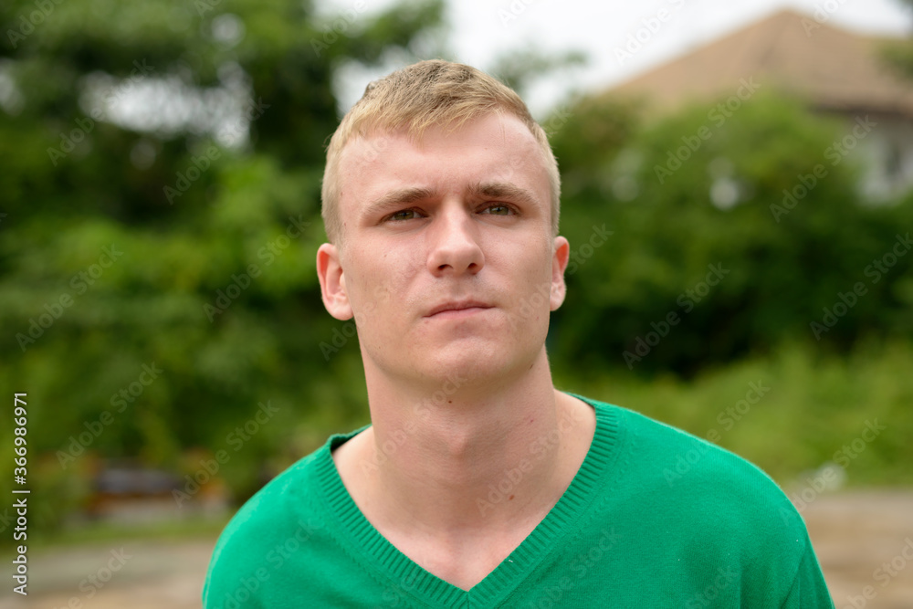 Portrait of young man with blond hair outdoors Portrait of young man with blond hair outdoors