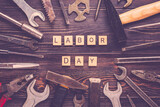 Happy Labor day concept Construction group home tools - hammer, saw, screwdriver, meter, pliers, wrench, chisel on blue wooden background Holiday card Top view Flat lay Text Banner