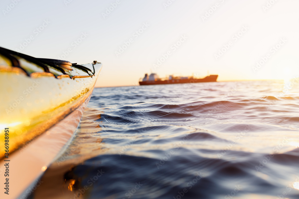 Sea kayak on a blurred background of the ship. Selective focus of the foreground.