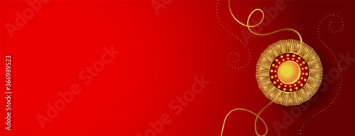 red banner with golden rakhi and text space