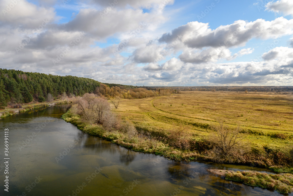 autumn landscape with river and clouds