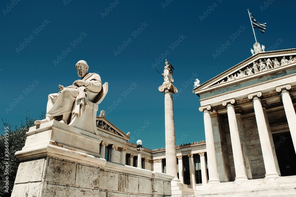 Greece, Athens, June 17 2020 - The statues of the ancient Greek philosopher Plato and Greek Goddess Athena outside of the Academy of Athens.