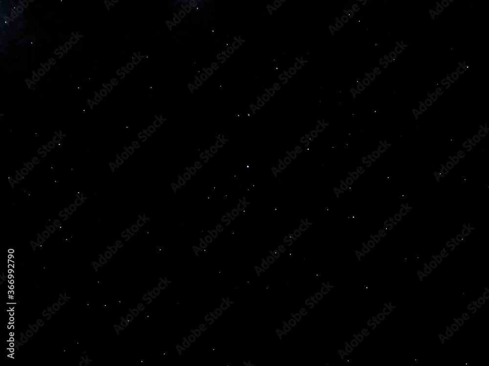 Obraz premium Flying dust particles on a black background. Stars in summer days 
