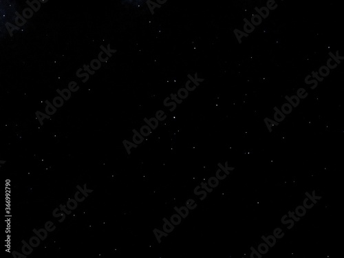 Flying dust particles on a black background. Stars in summer days  © yohananegusse