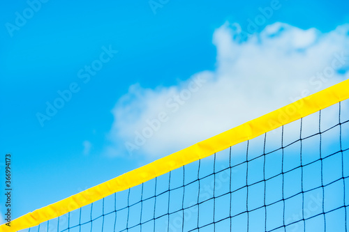 Beach volleyball and beach tennis net on the background of blue