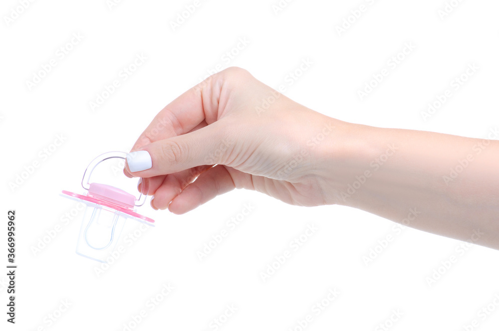 Hand holding pink baby soother on white background isolation Hand holding pink baby soother on white background isolation