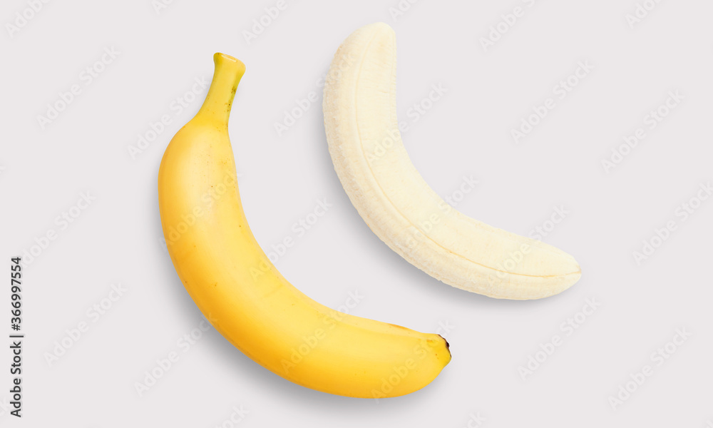 Banana and peeled banana on a white background