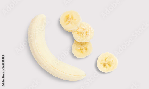 Peeled Banana and banana slices on a white background