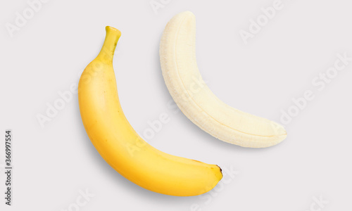 Banana and peeled banana on a white background