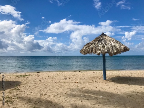 Peaceful and relaxing travel destination in Cuba  Caribbean   Dreamlike Playa Ancon with white sand  turquoise ocean and blue sky is an idyllic vacation paradise