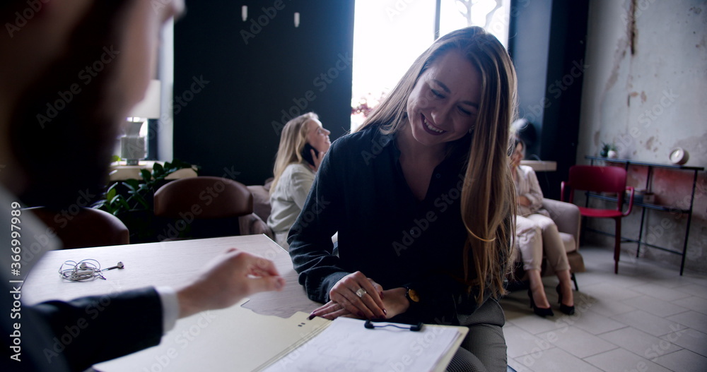 Young happy excited Caucasian woman applying for a job in modern multiethnic office, greeted by male HR slow motion. Young happy excited Caucasian woman applying for a job in modern multiethnic office, greeted by male HR slow motion.