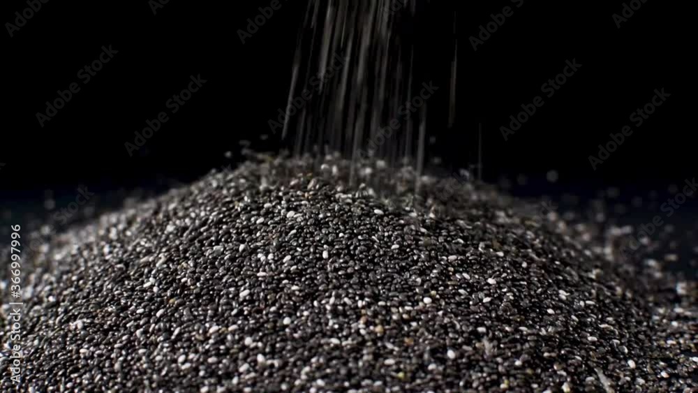 Chia falling on black background