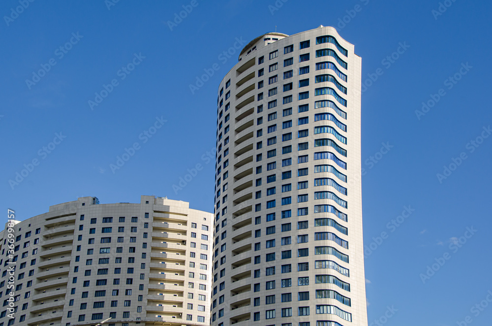 Modern high-rise residential buildings against the blue sky. Urban architecture.