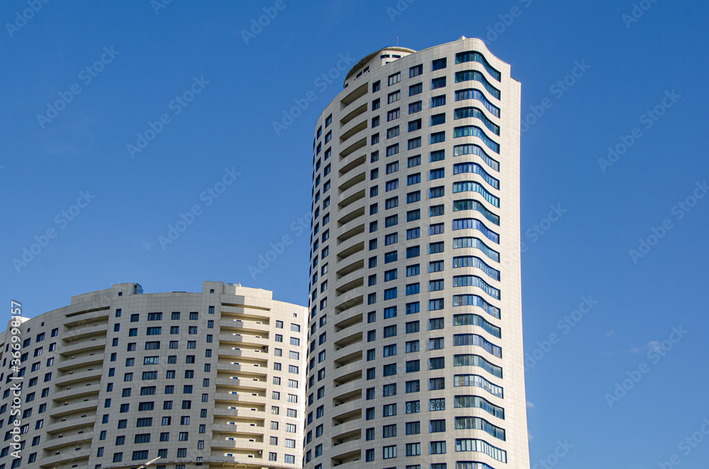 Modern high-rise residential buildings against the blue sky. Urban architecture. Modern high-rise residential buildings against the blue sky. Urban architecture.