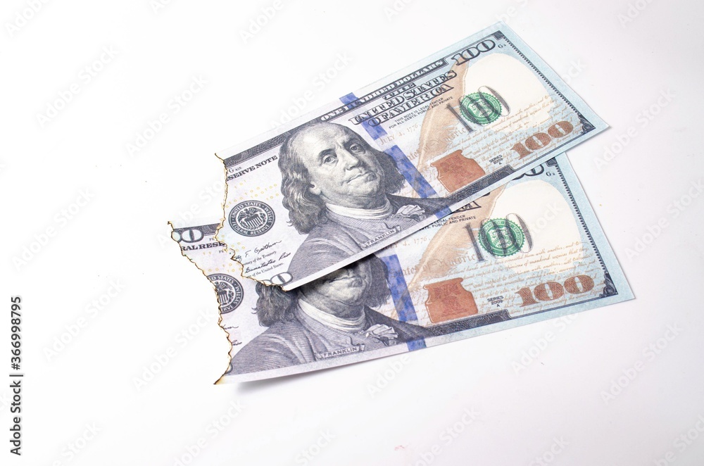 Burnt dollars. Burnt side view on white background banknotes in close-up Burnt dollars. Burnt side view on white background banknotes in close-up