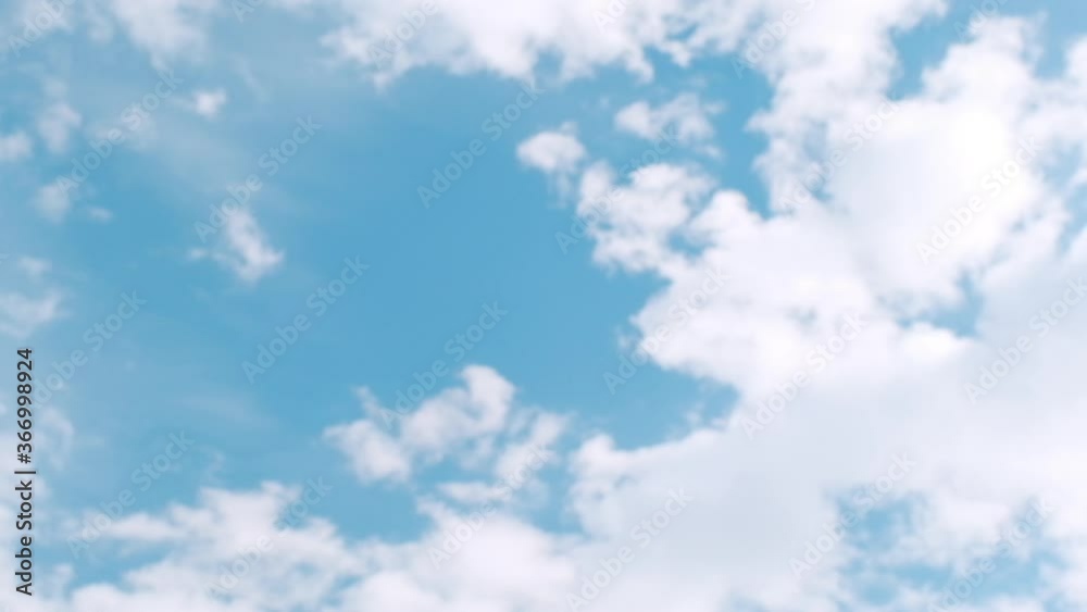 Happy child jumps very high on a trampoline against the blue sky. Blond boy jumps on a trampoline. Slow motion bottom view of a cheerful boy jumping on a trampoline. Children happiness. Happy child jumps very high on a trampoline against the blue sky. Blond boy jumps on a trampoline. Slow motion bottom view of a cheerful boy jumping on a trampoline. Children happiness.