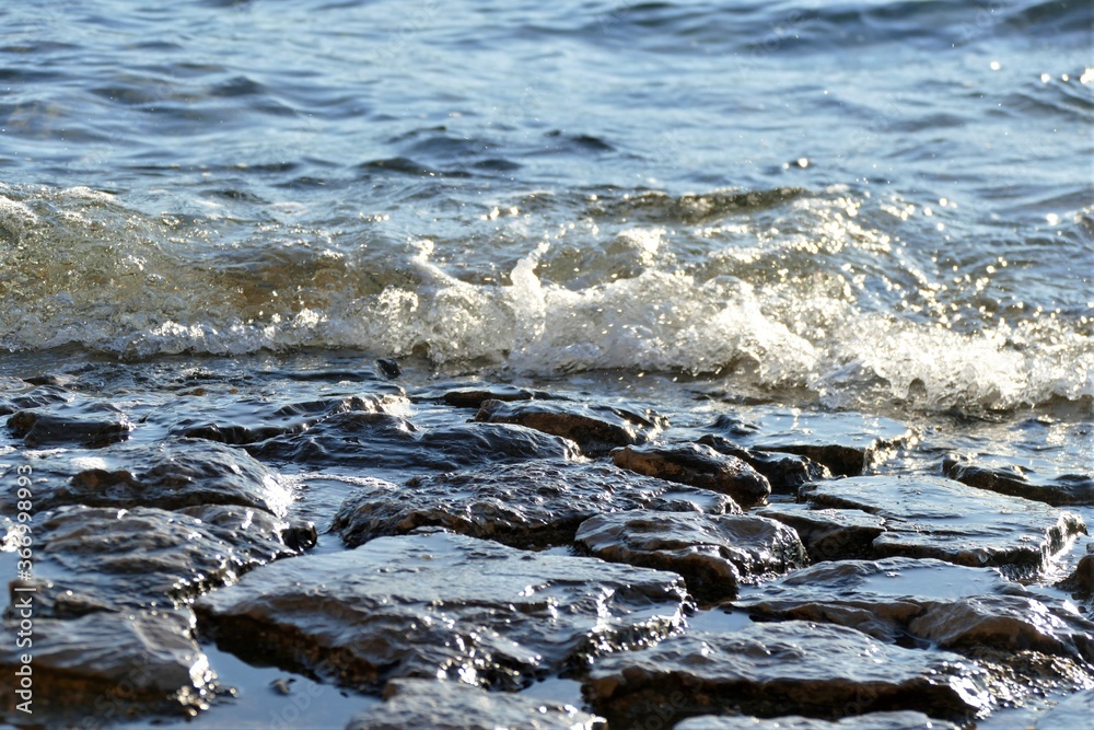 Stones and sea with waves with foam background Stones and sea with waves with foam background