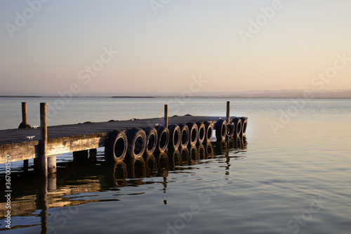 Jetty in a lagoon with sunset