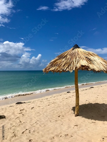 Peaceful and relaxing travel destination in Cuba  Caribbean   Dreamlike Playa Ancon with white sand  turquoise ocean and blue sky is an idyllic vacation paradise