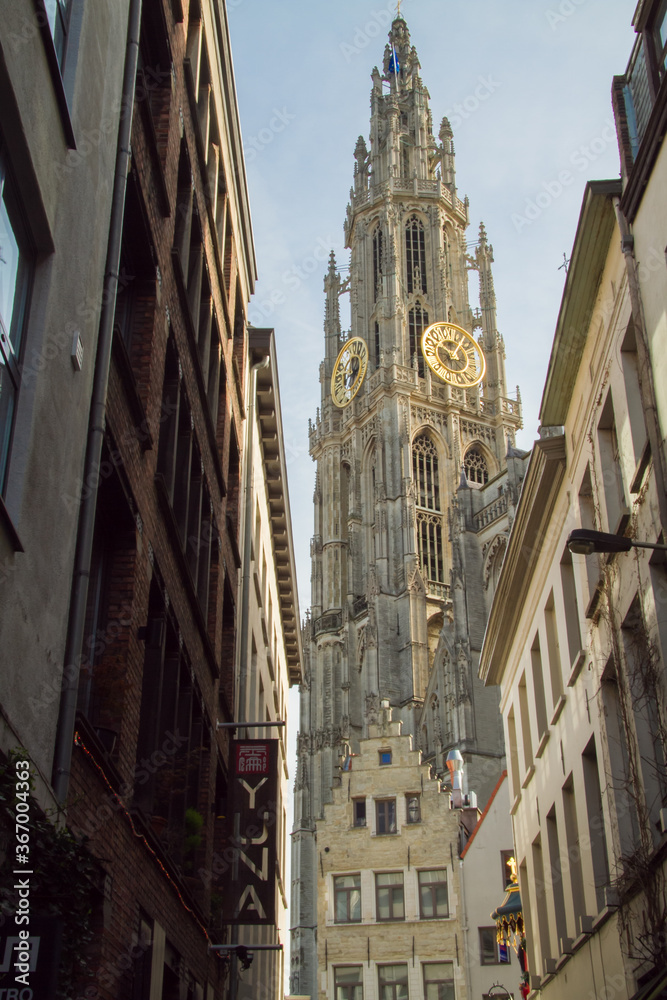 Antwerp, Belgium;  Looking down a narrow street at Cathedral of Our Lady church clock tower in Antwerp