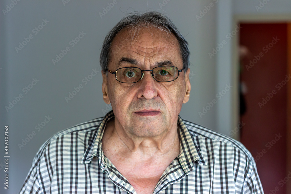 Shot of active senior Caucasian man. Portrait of old man feeling good to retire. Photo of senior man with eyeglasses standing by himself indoors at home. Copy space. Shot of active senior Caucasian man. Portrait of old man feeling good to retire. Photo of senior man with eyeglasses standing by himself indoors at home. Copy space.