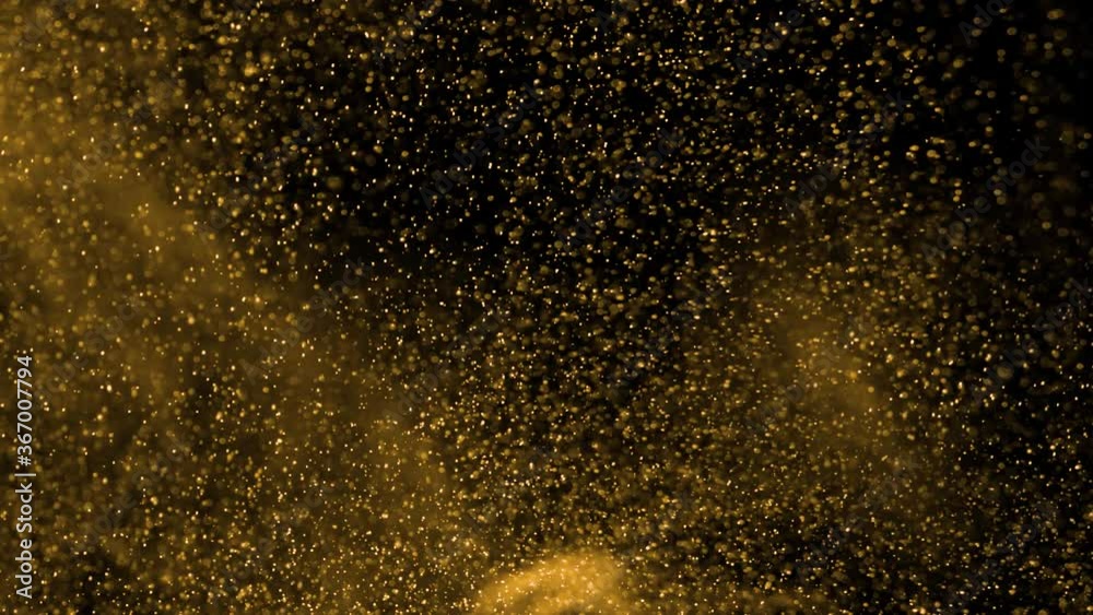 Gold dust particles fly in slow motion in the air lingering slowly. Dust Particles Background Bokeh Lights Background on Black Background 4k Footage Snow Particles Background. Gold dust particles fly in slow motion in the air lingering slowly. Dust Particles Background Bokeh Lights Background on Black Background 4k Footage Snow Particles Background.