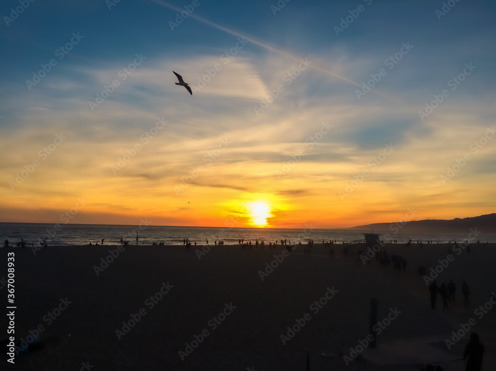 A sunset view of Santa Monica beach with lifeguard tower in California
