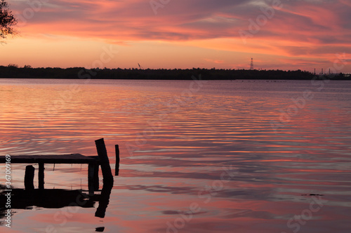 Konstfotografi Beautiful view of the sunset and reflections of wooden port on the water, Paradise beach,Playa Paraíso,Mexico,Tabasco,Villahermosa